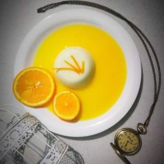 A picture of  Pannacotta with fresh orange .