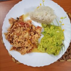 A picture of Ugali and Fried Eggs served with Guacamole.