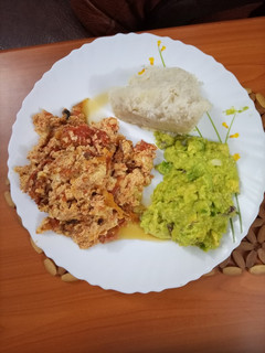 A picture of Ugali and Fried Eggs served with Guacamole.
