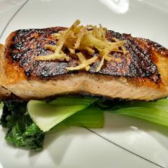 A picture of Blackened Asian salmon with crispy ginger sticks.