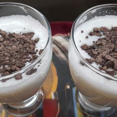 A picture of Banana milk shake with chocolate chips.