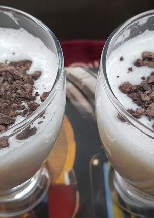 A picture of Banana milk shake with chocolate chips.