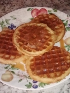A picture of My cinnamon waffles with caramel syrup.