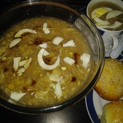A picture of Chicken corn soup with chicken buns.