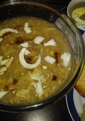 A picture of Chicken corn soup with chicken buns.