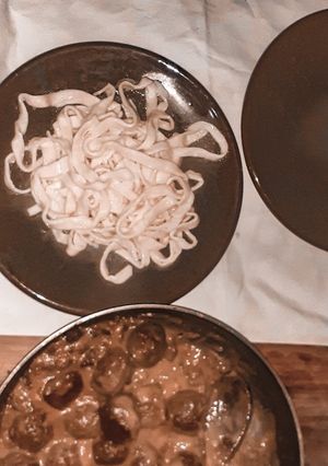 A picture of Fresh pasta and meat balls.