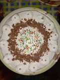 Ice cake with topping of sprinkles and chocos
