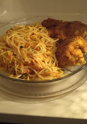 A picture of Fried spaghetti with coated chicken.