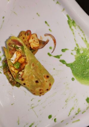 A picture of Veg kathi roll with yoghurt mint chutney.