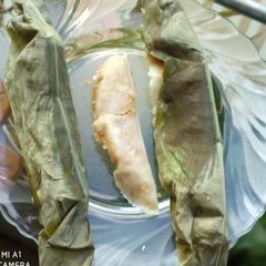 A picture of Sweet Rice Dumplings Steamed In Turmeric Leaves.