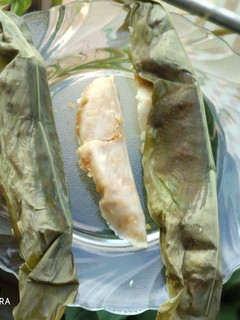 A picture of Sweet Rice Dumplings Steamed In Turmeric Leaves.