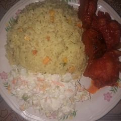 A picture of Fried rice and salad with sauced fried turkey and mackerel fish.