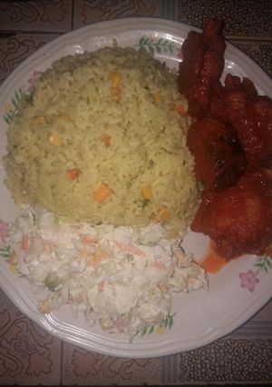 A picture of Fried rice and salad with sauced fried turkey and mackerel fish.