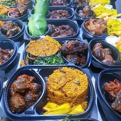 A picture of Jollof rice with fried Gizzard and vegetable.