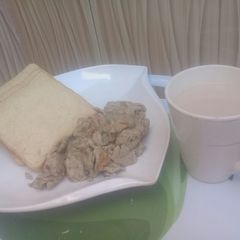 A picture of Scrambled eggs with bread and tea.