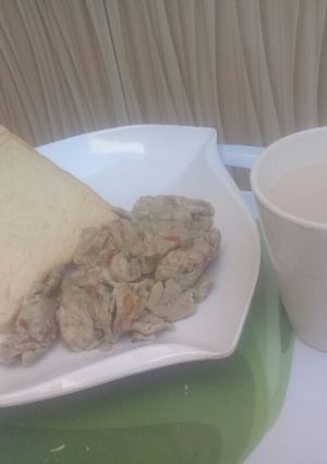 A picture of Scrambled eggs with bread and tea.