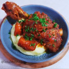 A picture of Lamb shanks with mashed potato.