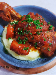 A picture of Lamb shanks with mashed potato.