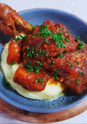 A picture of Lamb shanks with mashed potato.