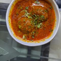 A picture of Meat balls in red gravy.