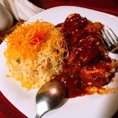 A picture of Red dragon chicken with egg fried rice.