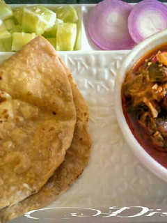A picture of Warli style mutton curry.