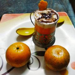 A picture of Kinnow juice with vanilla ice cream.