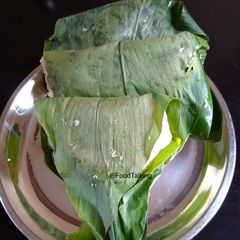 A picture of Haladi Patra Pitha/Turmeric Leaves covered Cakes.