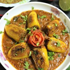 A picture of Stuffed Chilli Pepper in Tomato Gravy.