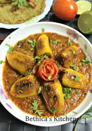 A picture of Stuffed Chilli Pepper in Tomato Gravy.