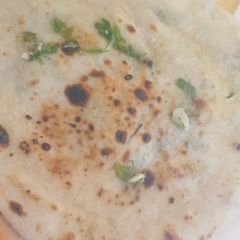 A picture of Cheese stuffed garlic naan.