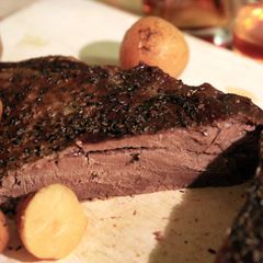 A picture of Bison Brisket with Roasted Potatoes & Gravy.