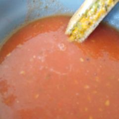 A picture of Roast tomato soup with pesto and grilled cheese toasties.