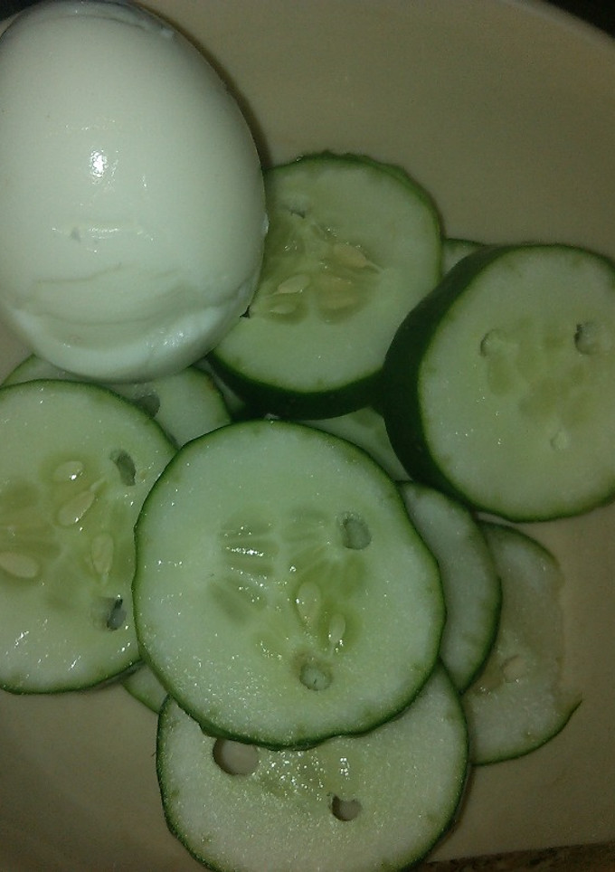 A picture of Boiled egg with cucumber.