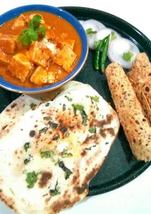 A picture of Paneer tikka,butter naan and papad.