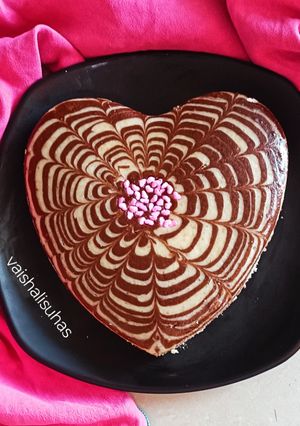 A picture of Valentine's special Vanilla Chocolate Heart Cake / Zebra cake / Eggless cake.