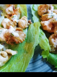 A picture of Chicken wrapped in lettuce with tartar sauce and mozzarella.
