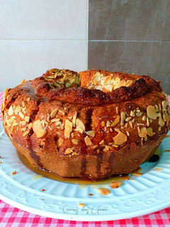 Una foto de Bizcocho crocante con glaseado de clementinas y almendras