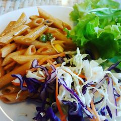 A picture of Indian style corn mutter Penne pasta with salad.