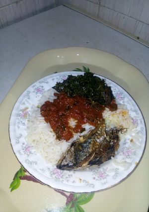 A picture of Rice and stew with fish and veggies.