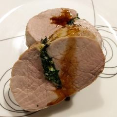 A picture of Pork tenderloin "stuffed" with spinach, lemon and rosemary.