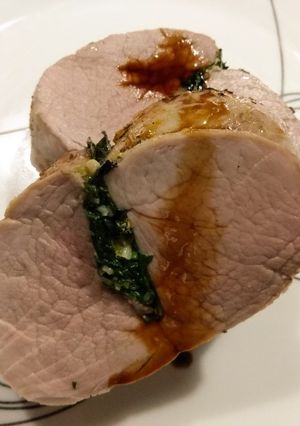 A picture of Pork tenderloin "stuffed" with spinach, lemon and rosemary.