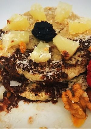 Una foto de Pancakes de banana y avena con ananá, salsa de chocolate, coco y más! Súper saludable y fit