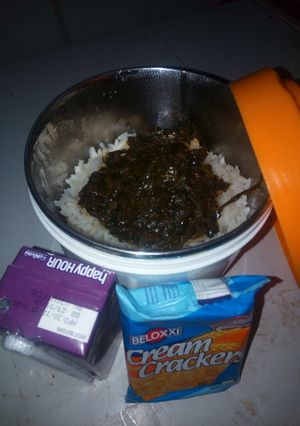 A picture of White rice with vegetable soup.