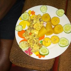 A picture of Boiled plantain with fried egg and cucumber.