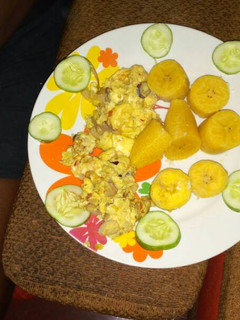 A picture of Boiled plantain with fried egg and cucumber.