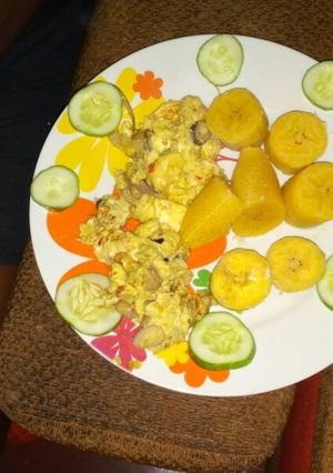 A picture of Boiled plantain with fried egg and cucumber.