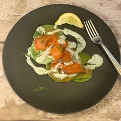 A picture of Spinach pancakes, smoked salmon with a creme fraiche and dill.