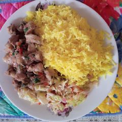 A picture of Tumeric rice with cabbage and pork.