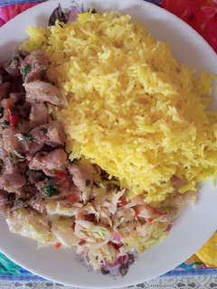 A picture of Tumeric rice with cabbage and pork.